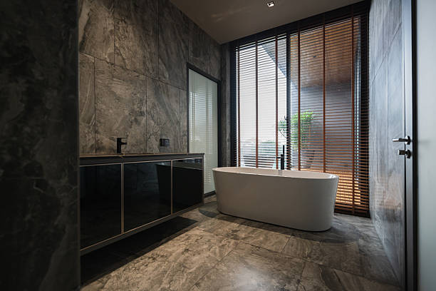 Beautiful contemporary home interior features clean minimalist design with natural daylight and earthy material palette. Sustainable decor elements showcase biophilic aesthetics and organic modernism principles