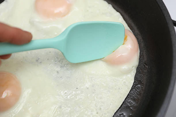 istock Eggs are fried in a frying pan. Cooking breakfast 2232221123