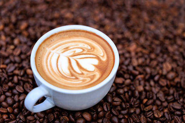 istock cappuccino white cup and roasted coffee beans backgrounds abstrack, top view 2232221628