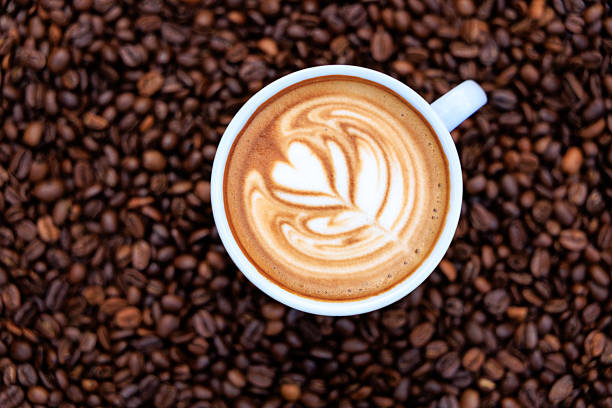 istock cappuccino white cup and roasted coffee beans backgrounds abstrack, top view 2232221643