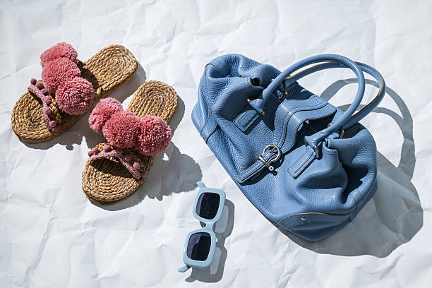 Summer Accessories Flat Lay with Straw Sandals and Blue Handbag.