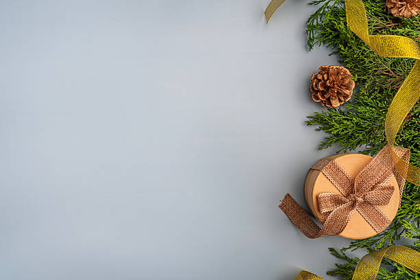 istock Golden Christmas Decorations with Greenery on Light Background 2232224706