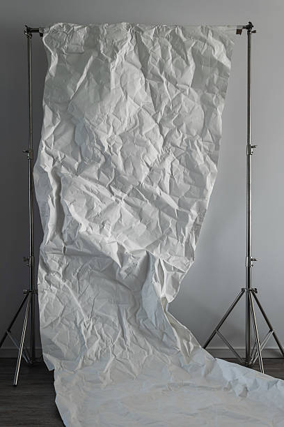 istock Crumpled White Paper Backdrop on Stands in Photo Studio 2232225221