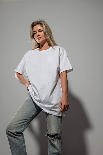 istock Confident Woman Wearing Oversized White T-Shirt with Blank Space for Mockup 2232226827