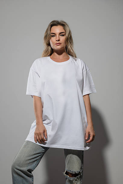 istock Confident Woman Wearing Oversized White T-Shirt with Blank Space for Mockup 2232227065