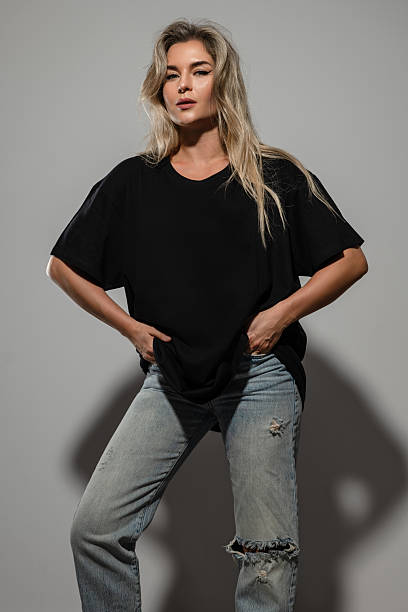 istock Confident Woman Wearing Oversized Black T-Shirt with Blank Space for Mockup 2232227596