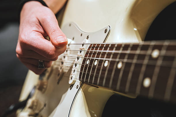 istock Playing electric guitar, close up on hand 2232228041