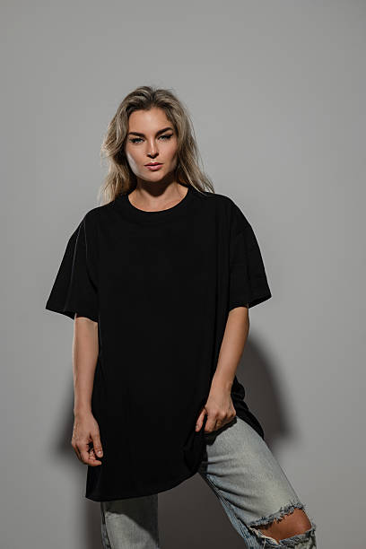 istock Confident Woman Wearing Oversized Black T-Shirt with Blank Space for Mockup 2232228055
