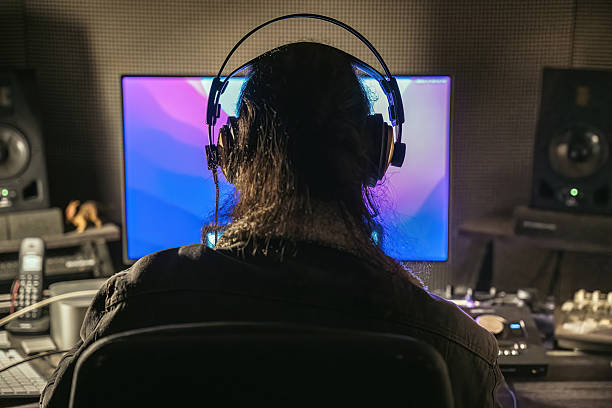 istock Man with headphones in recording studio 2232228071