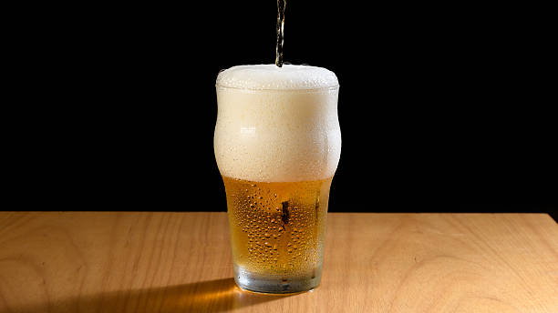 istock Pouring Beer into a Glass with Foam 2232229251
