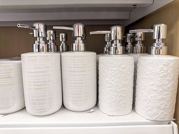 White ceramic for liquid soap or shampoo dispenser on a shelf lying in a stack in a store
