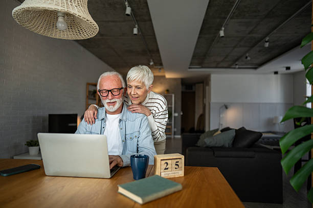 istock Happy senior couple using laptop at home 2232233331
