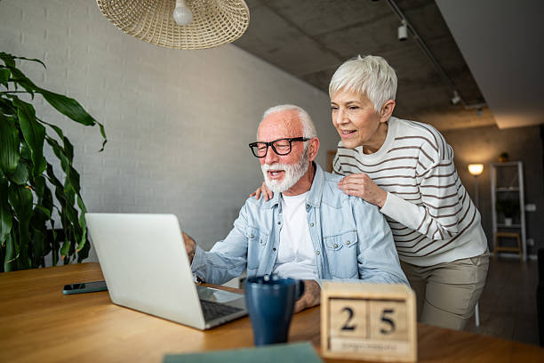 istock Happy senior couple using laptop at home 2232233945