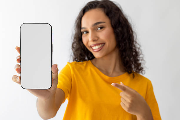 istock Beautiful woman pointing out a smart phone screen 2232235724