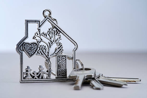 Close-Up Of House Keys Over White Background
