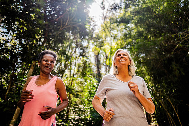 istock Senior friends talking and doing jogging on the public park 2232241829
