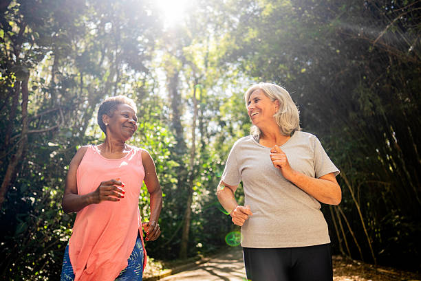 istock Senior friends talking and doing jogging on the public park 2232241837