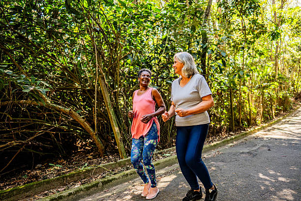 istock Senior friends talking and doing jogging on the public park 2232241840