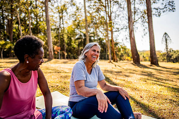 istock Senior friends practicing yoga together outdoors in the park 2232241961