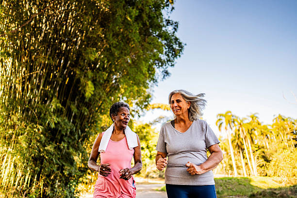 istock Senior friends talking and doing jogging on the public park 2232242151