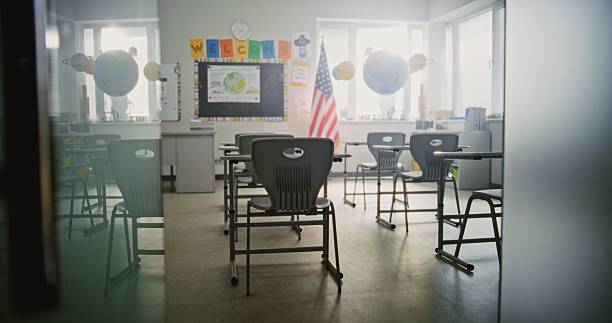 istock American Primary School: Interior of Modern Empty Classroom with Desks for Students 2232243633