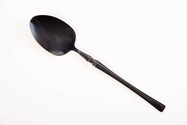 istock Spoon, a beautiful dark metal spoon, white background, selective focus. 2232243785