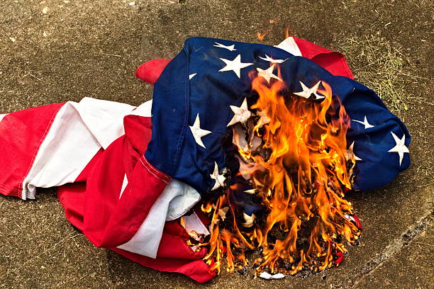 istock Burning a US Flag Wide Shot 2232244137