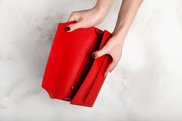 istock Fashionable red female handbag on a white granite texture 2232248193