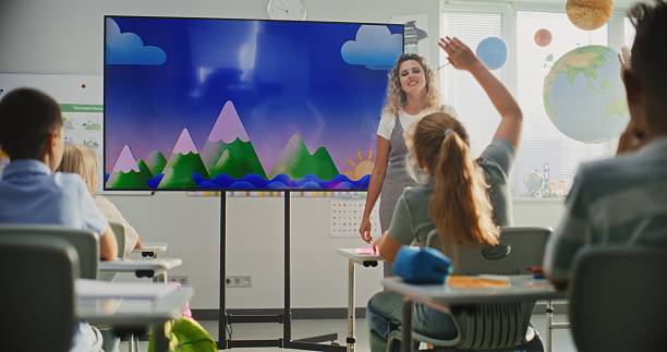 istock Geography Class: Female Teacher Teaching Primary School Children Using Digital Screen 2232248510