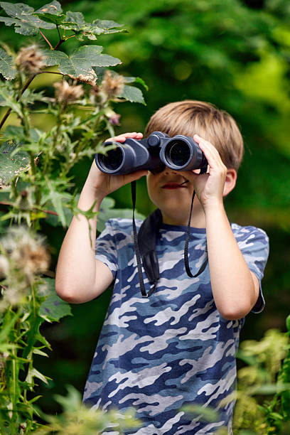 istock Boy birdwatching in woodland 2232250945
