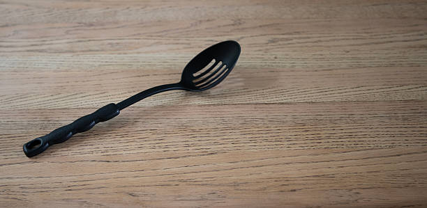 Plastic Cooking Spoon on Wood Background. Shot with a Canon EOS Mark V.