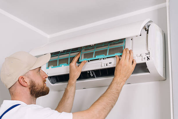 istock Expert performing air conditioning maintenance and filter replacement in apartment 2232253165