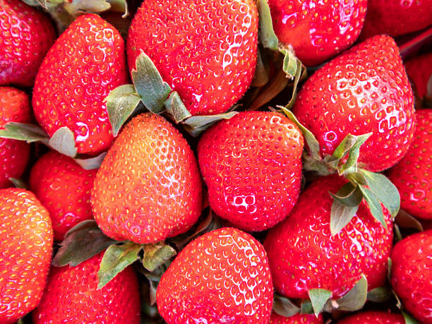 Freshly Picked Strawberries Create a Vibrant Display at a Local Market During Summer's Peak Season