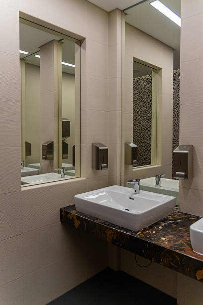 istock Modern restaurant restroom interior with sinks, mirrors, and soap dispensers. 2232253944