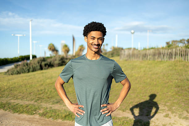 istock Young sportsman smiling and posing in a park 2232256749