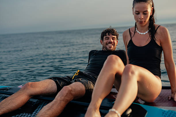 istock Couple relaxing on paddle board after surfing session 2232256804