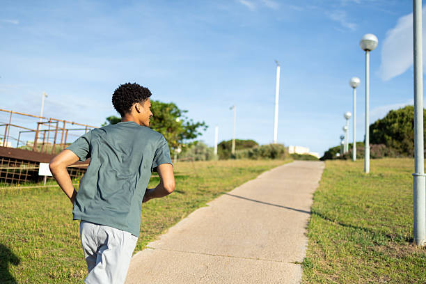 istock Young man running outdoors in a city park 2232256833