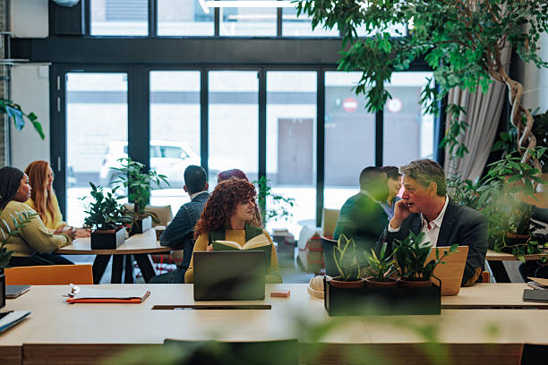 istock Coworkers collaborating in a green and sustainable office space 2232256837