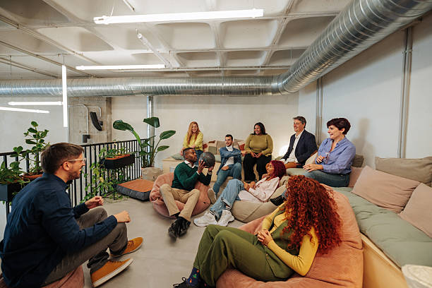 istock Creative team relaxing and brainstorming on beanbags in modern office 2232257046