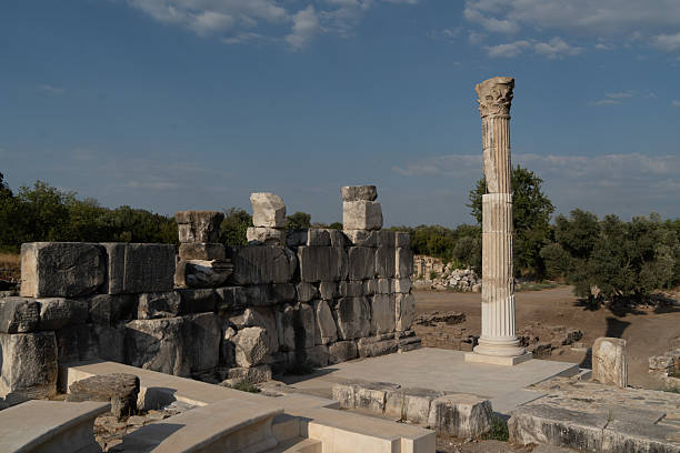 Muğla, Turkey - August 26, 2025: Stratonikeia, located in the Eskihisar Quarter 7 km west of Yatağan District, is one of the largest marble cities of the ancient world. The site preserves layers of history from the Hittites, Archaic and Classical periods, Khrysaoris, Idrias and Hekatesia, to the Hellenistic, Roman, Byzantine, and Turkish Principalities. Today, the ancient city is a popular destination for tourists exploring its monumental gates, colonnaded streets, theaters, and well-preserved structures. An evening view from Stratonikeia reflects both its archaeological significance and its role as a cultural heritage site attracting visitors from around the world.