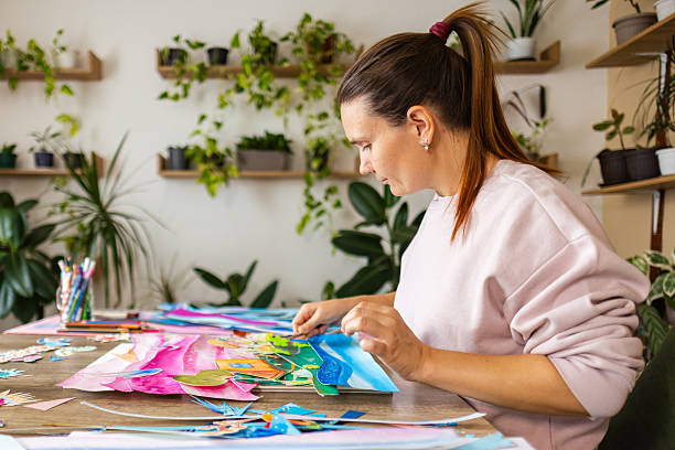 istock Side view of a woman creating collage art 2232259813