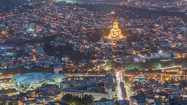 istock Illuminated Tsminda Sameba Cathedral or Holy Trinity Cathedral of Tbilisi and Public Service Hall aerial day to night timelapse Georgia 2232260201