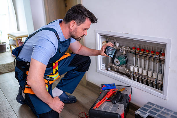 istock Handyman inspecting heating system components during home repair visit 2232260605