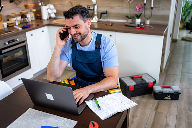 istock Handyman discussing household repairs while working in a modern kitchen setting 2232261447