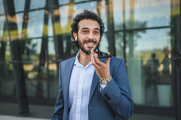 istock Smiling businessman using voice assistant on smart phone outdoors 2232262920