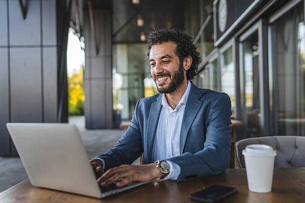 istock middle eastern businessman working on laptop in outdoor cafe setting 2232263034