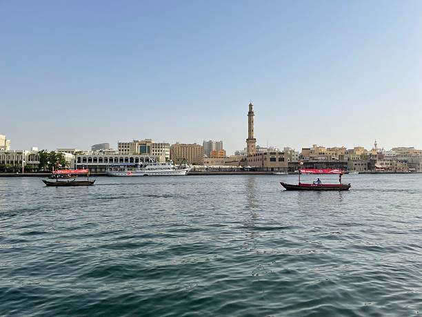 istock Boats on Dubai Creek with Mosque Minaret View 2232263697