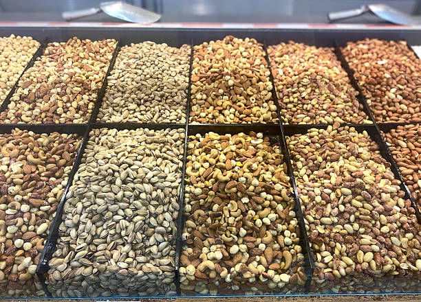 istock Brightly lit supermarket display case with different varieties of nuts. Concept: food, drinks, healthy snack, retail 2232263985