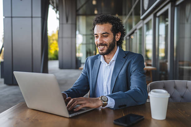 istock middle eastern businessman working on laptop in outdoor cafe setting 2232264079