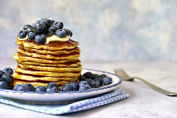istock Stack of fresh hot banana pancakes with maple syrup and blueberries for a breakfast. 2232266964